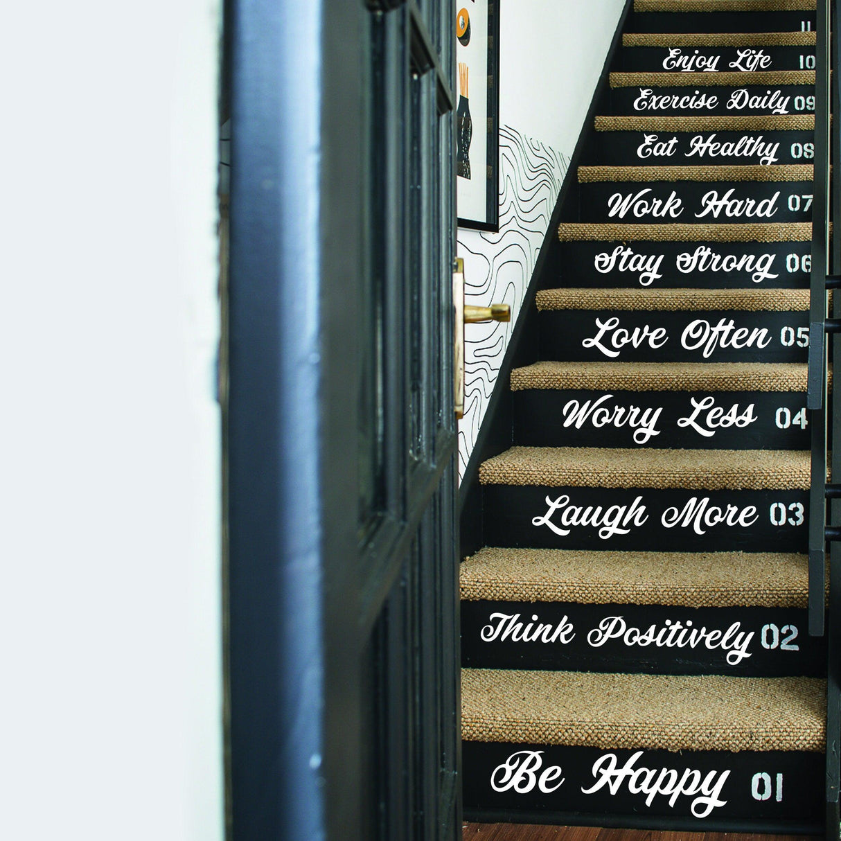 Decorative vinyl decals with motivational quotes on staircase risers, enhancing home decor.