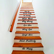 Stair riser with vinyl decals featuring motivational quotes like 'Enjoy Life', 'Work Hard', and 'Be Happy'.