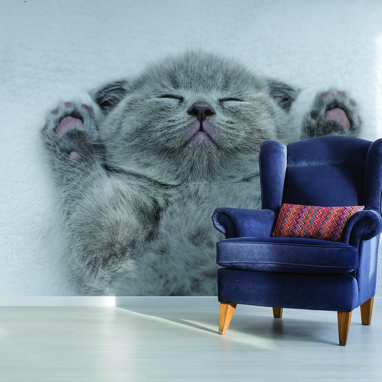 Gray kitten vinyl wall decal in cozy room with blue chair, perfect for cat lovers' home decor.