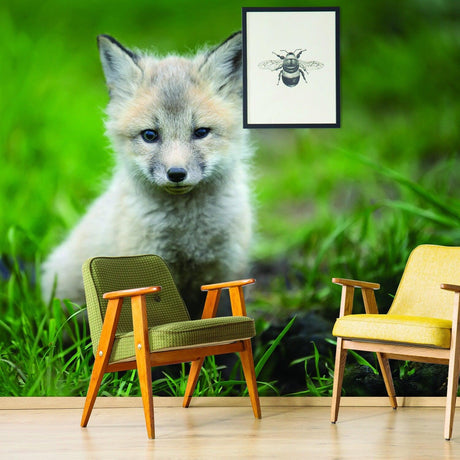 Cute little fox wallpaper decor with stylish chairs in a home nursery or kid's bedroom setting.