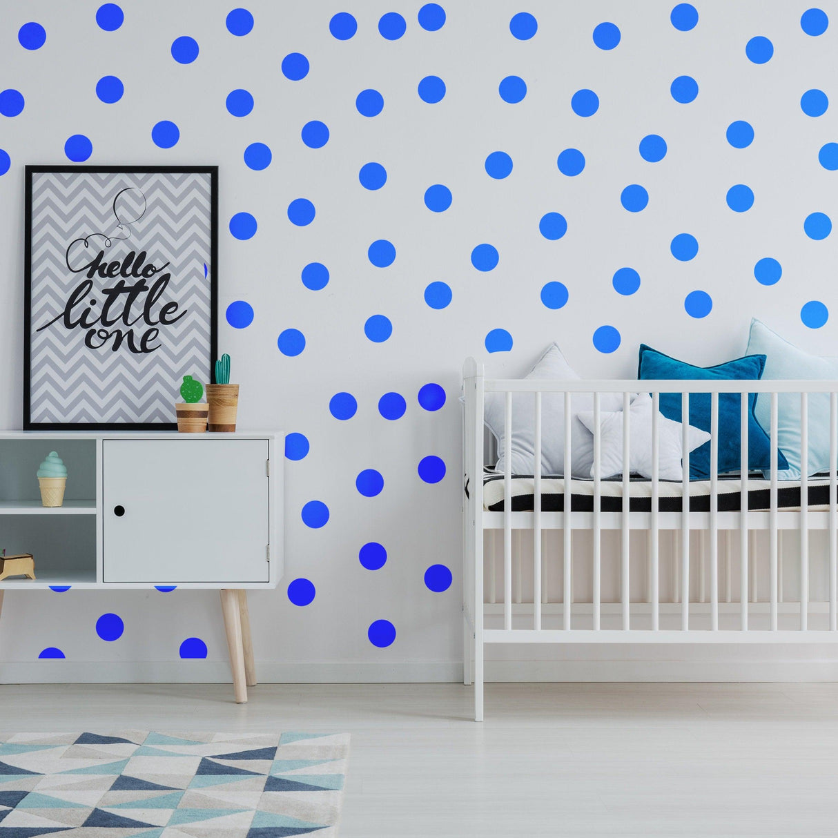 Blue circle wall stickers decorate a nursery, adding color and personality to the space with a modern design.