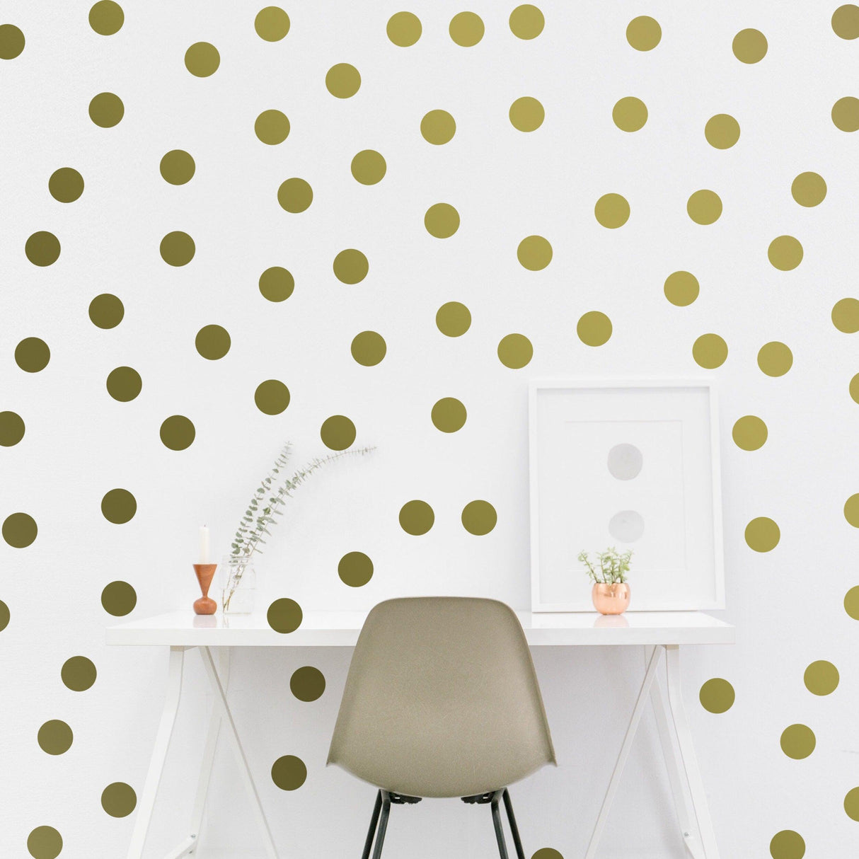 Elegant gold circle wall stickers on white wall, enhancing modern workspace with stylish decor.