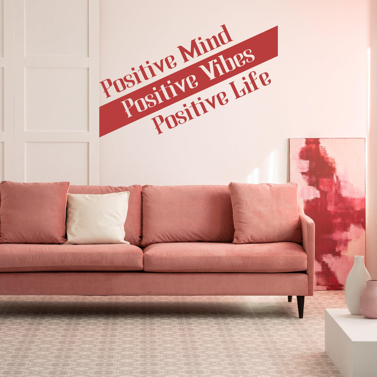 Inspirational vinyl decal displaying 'Positive Mind, Positive Vibes, Positive Life' on a stylish wall above a pink sofa.