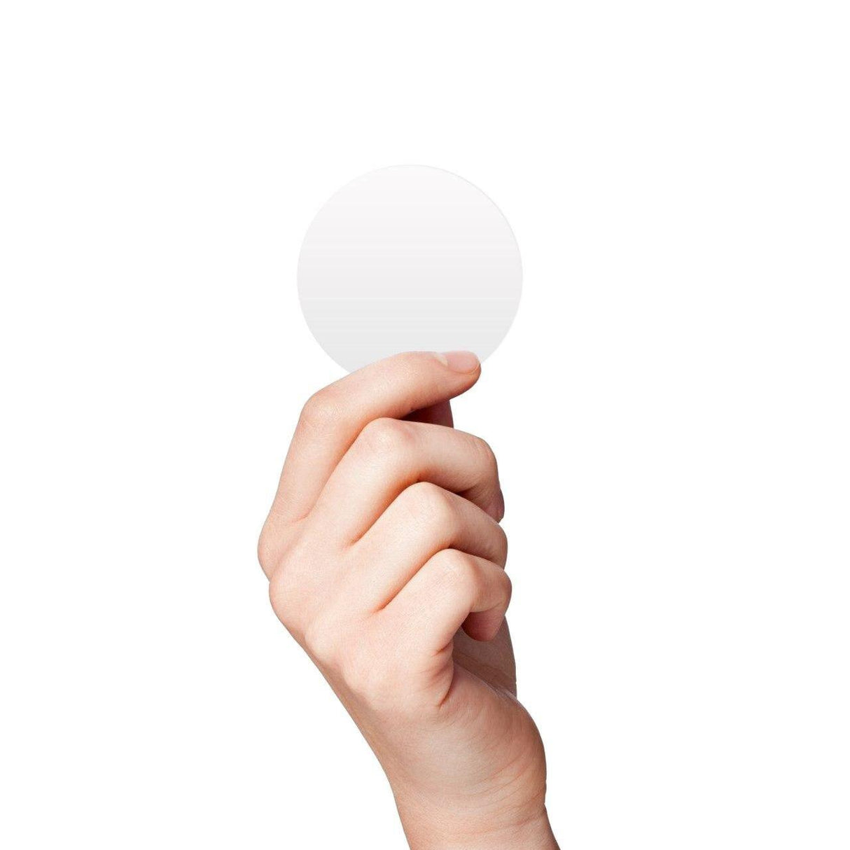 Hand holding a white round circle dot sticker on a plain background.