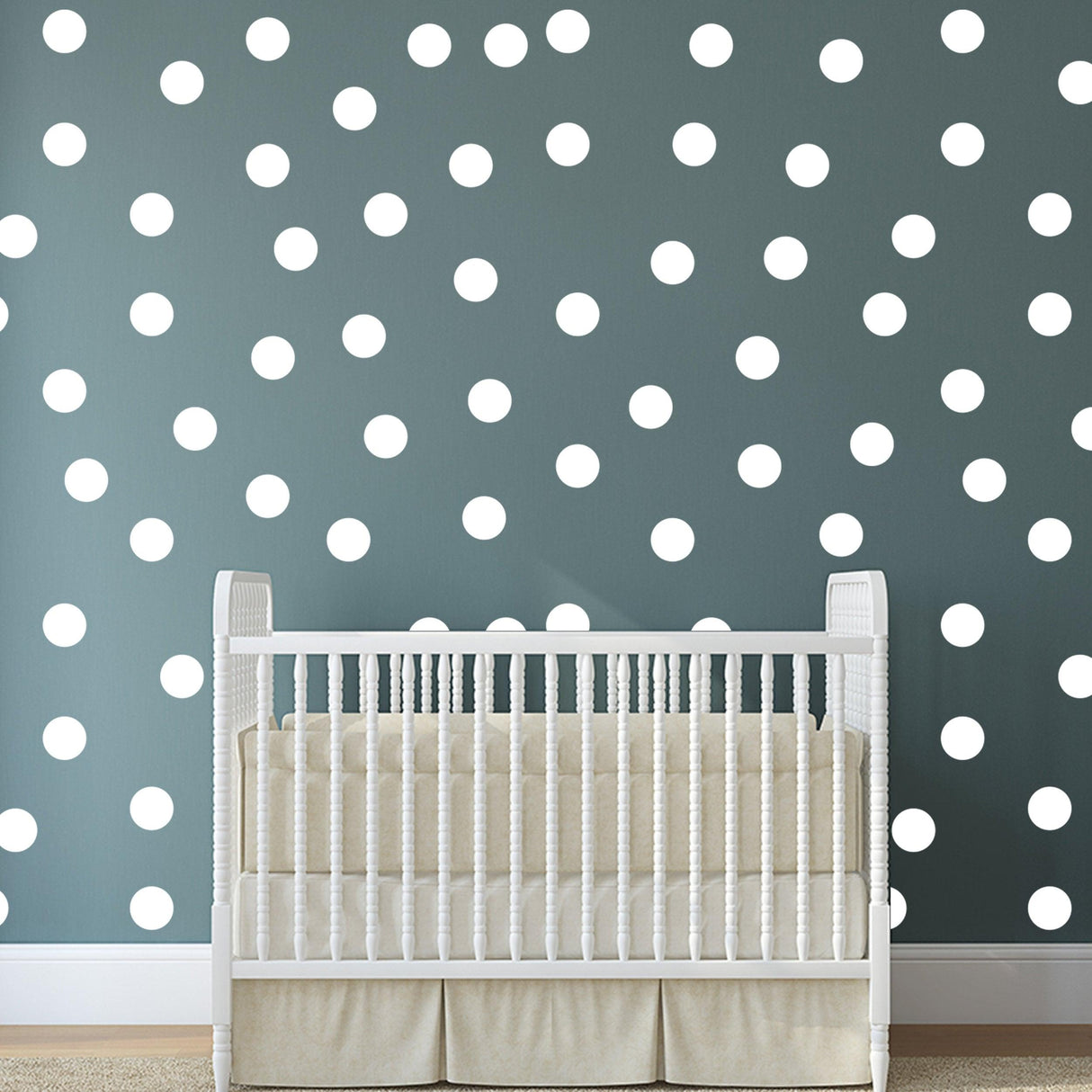 Nursery room with white round dot wall decals and a white crib, creating a playful and modern decor.
