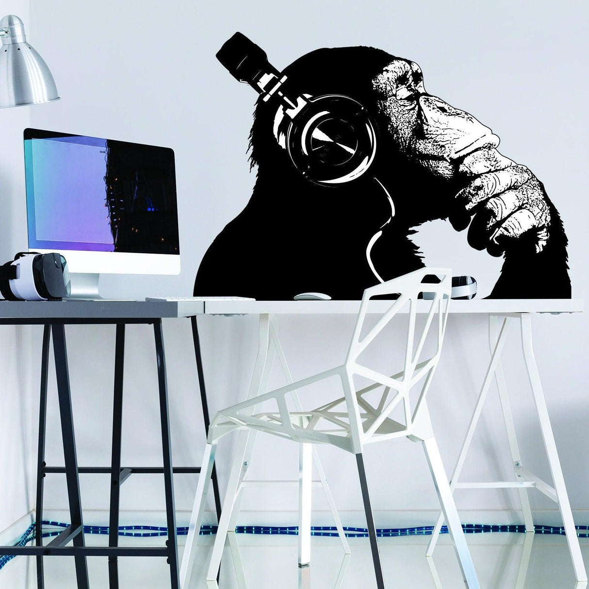 Playful monkey with headphones sitting at a desk, perfect for personalizing laptops and phones.