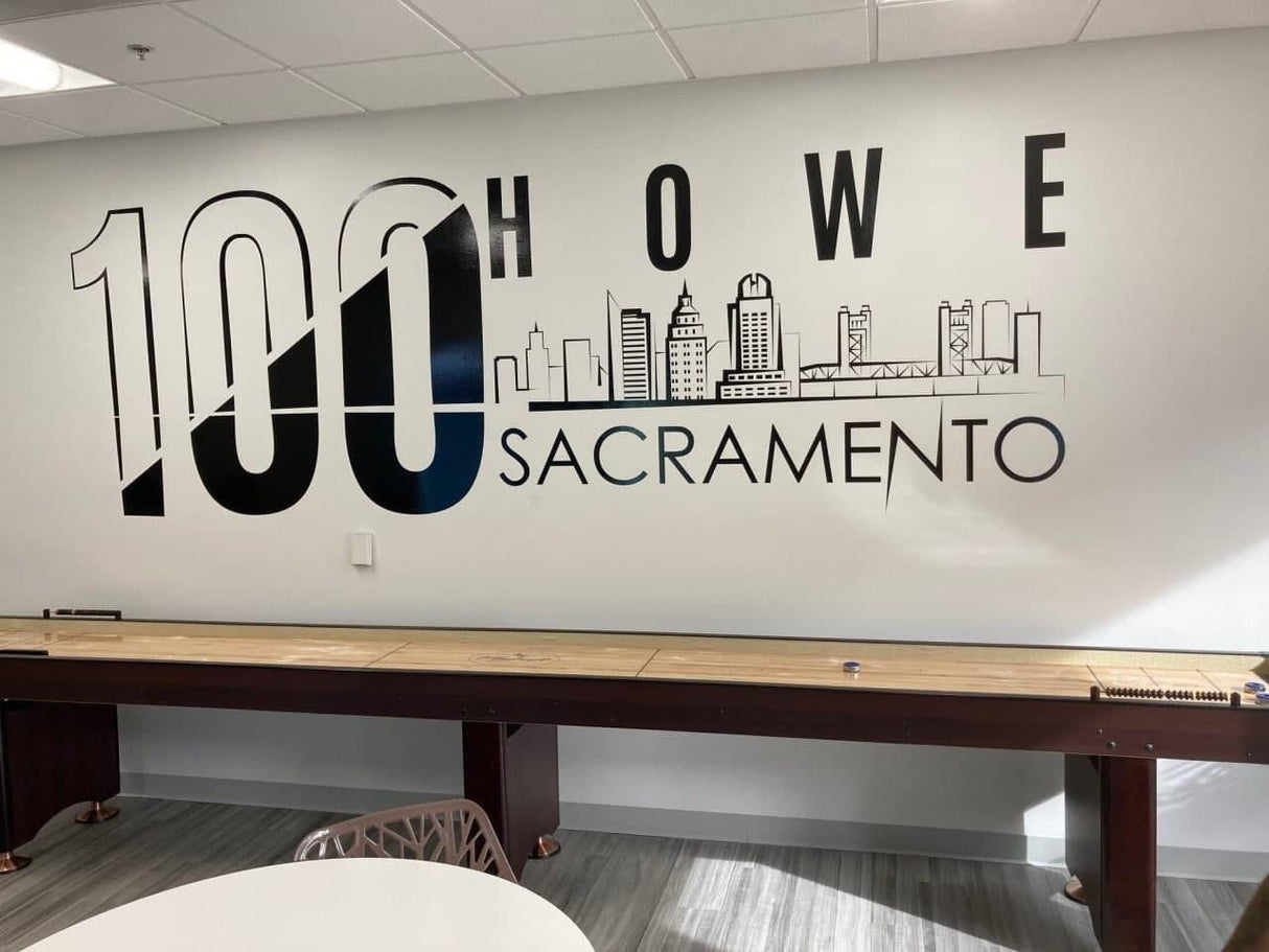 Interior view of a wall featuring '100 Howe Sacramento' mural with city skyline design.