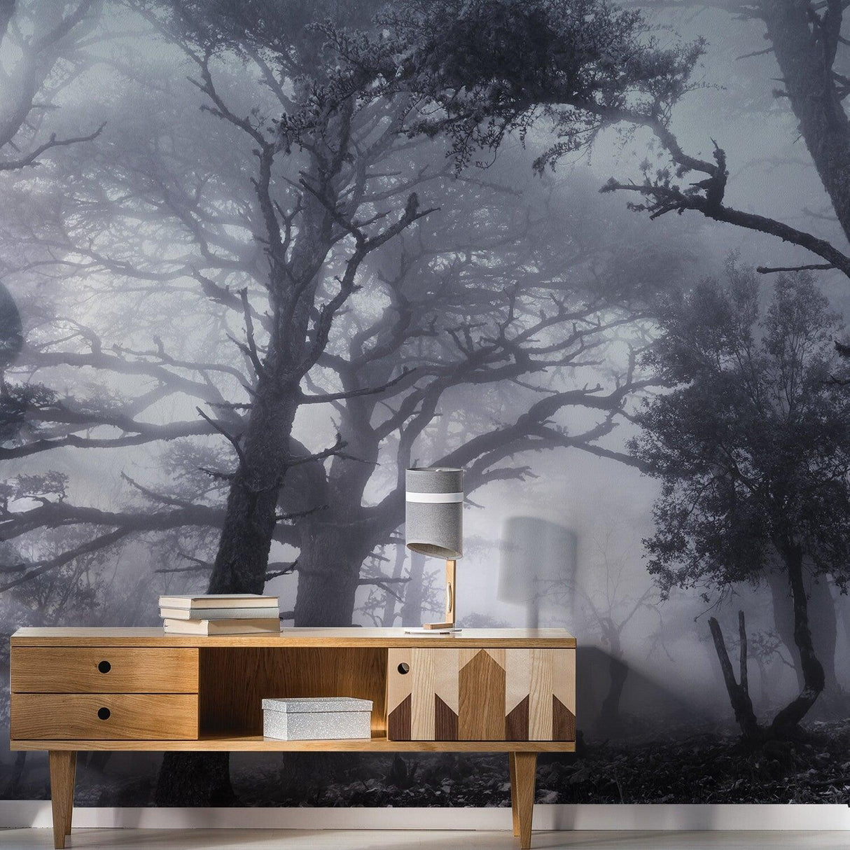 Foggy forest wallpaper mural with tall trees, creating a mystical atmosphere in a modern interior setting.