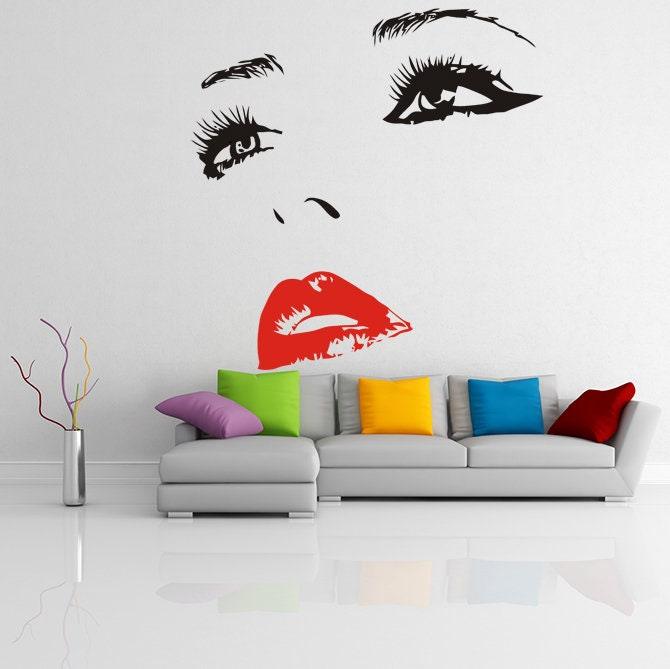 Elegant woman eyes sticker with red lips as wall decor, enhancing a stylish living room's modern interior design.