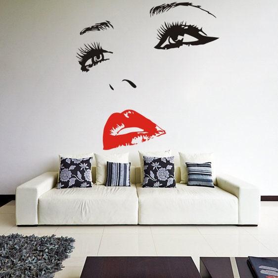 Elegant woman eye and red lips wall decal above a modern white couch in a stylish living room.