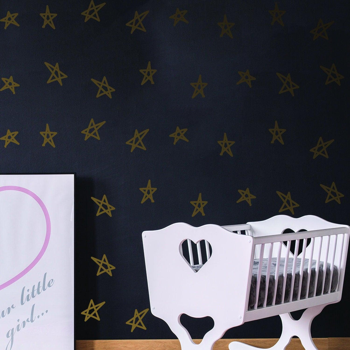 Nursery room featuring removable star wall decals in gold on a dark wall with a white crib.