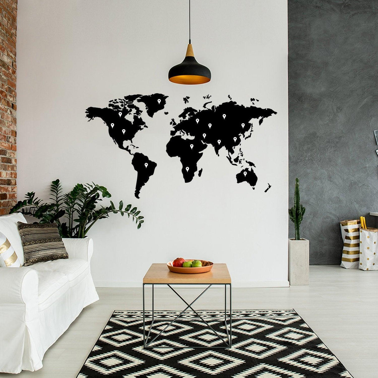 Large black world map wall decal in a modern living room with plants and a coffee table.