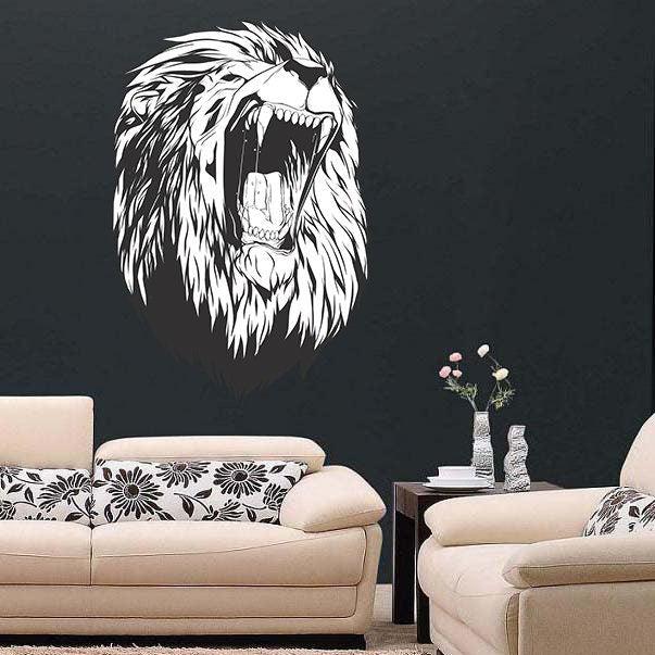 Large lion head wall decal in a living room, showcasing intricate details on a dark wall.
