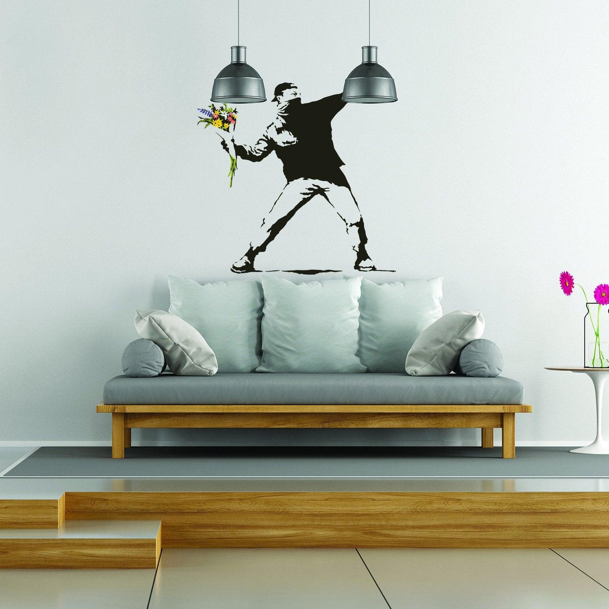 Banksy Flower Thrower wall decal above a modern couch in an urban style living room