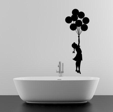 Banksy Girl With Balloons wall decal above a modern bathtub, adding artistic flair to the bathroom decor.
