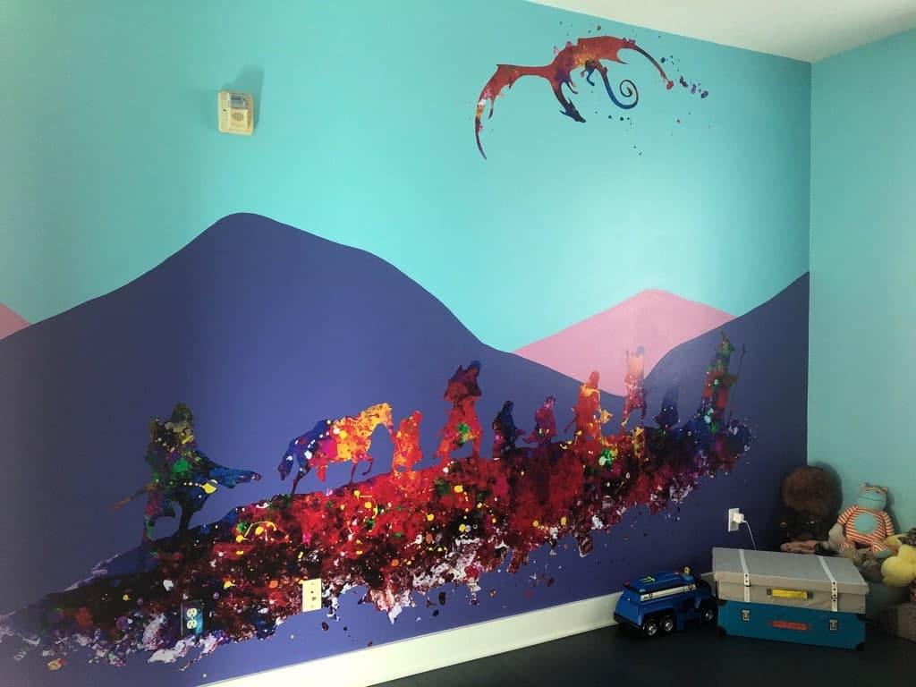 Colorful mural featuring mountains, a dragon, and characters in a playful children's room decor.