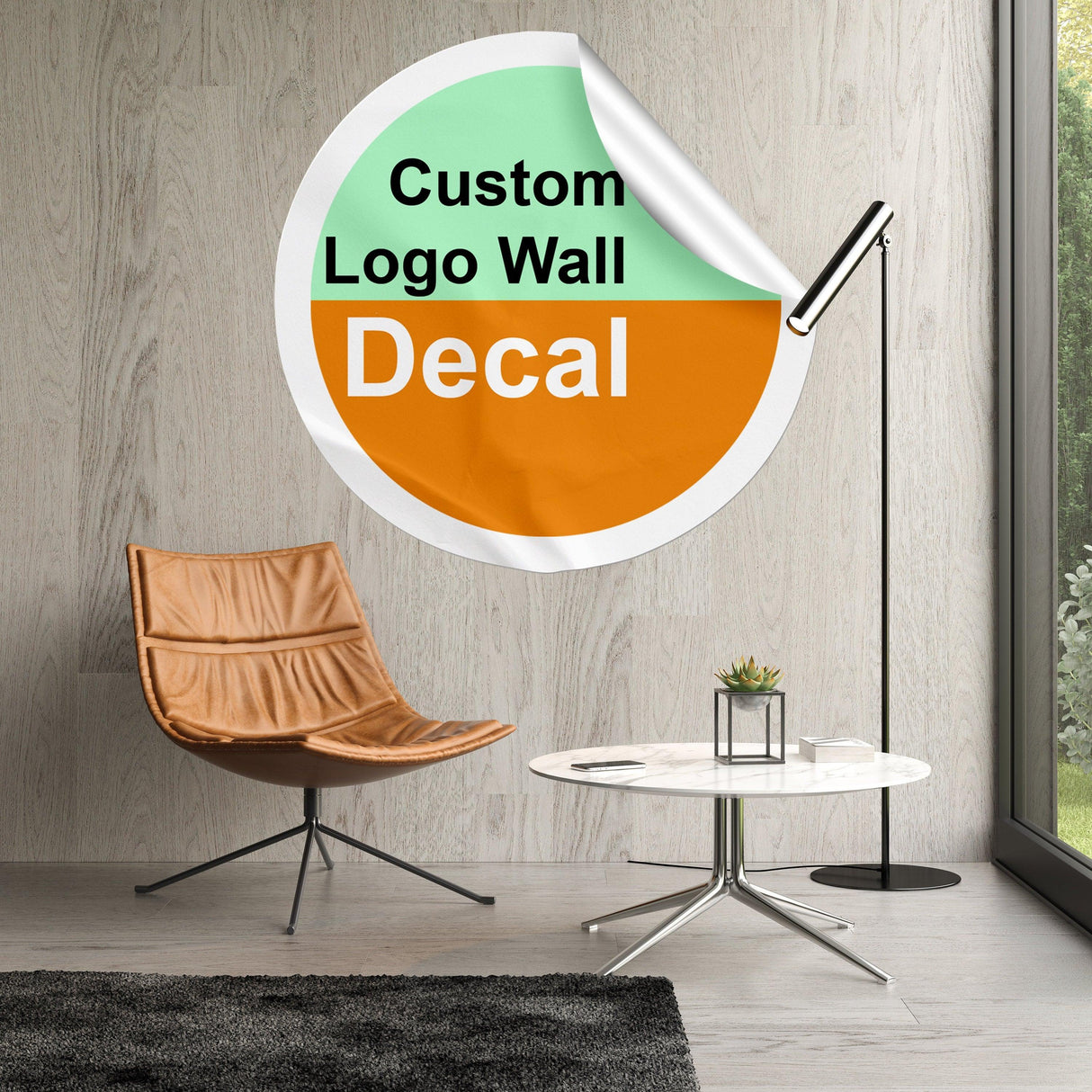 Custom logo wall decal in stylish living room setting with modern chair and lamp.