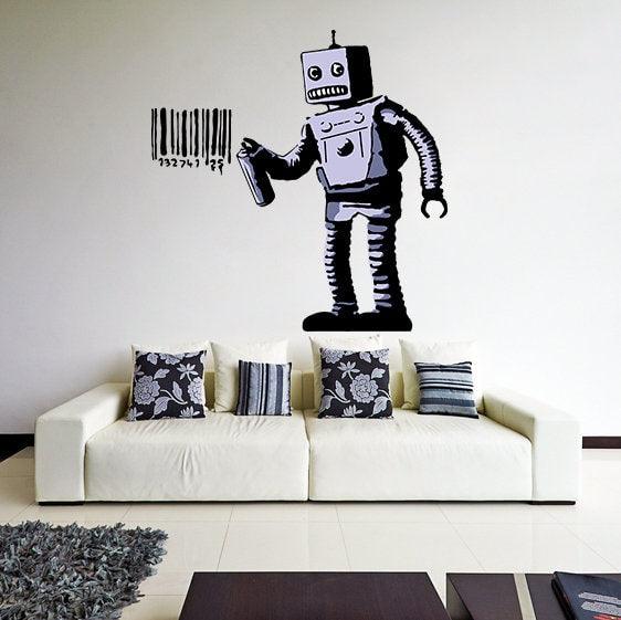 Banksy Barcode Robot vinyl sticker on wall above a white sofa, featuring a robot with barcode graffiti art.