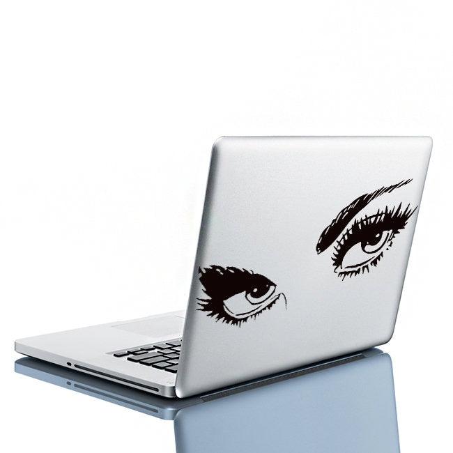 Elegant black eye decal on a silver laptop, perfect for stylish bedroom wall decor.