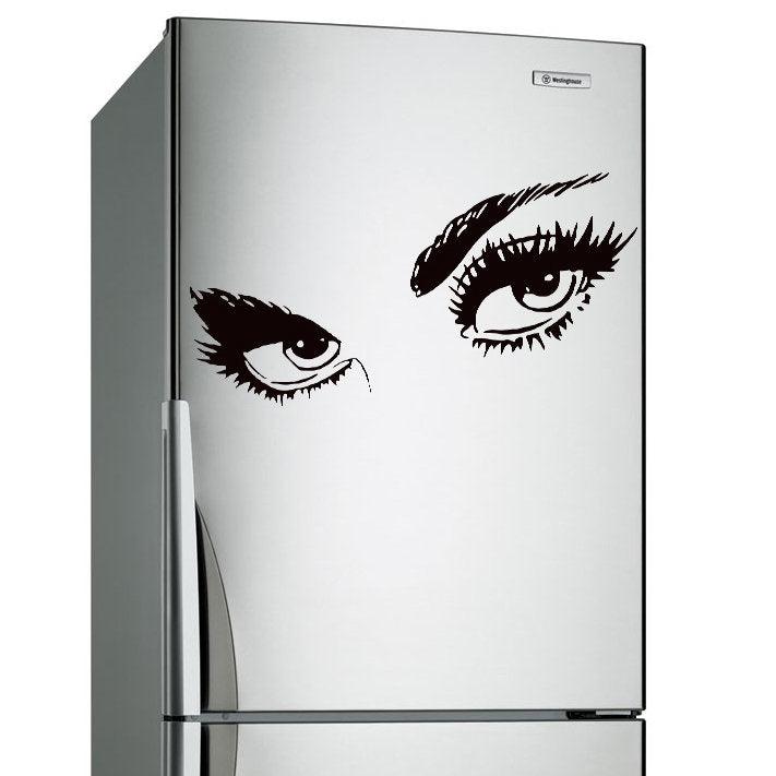 Stylish black eye decal on a silver refrigerator, perfect for adding a chic touch to home decor.