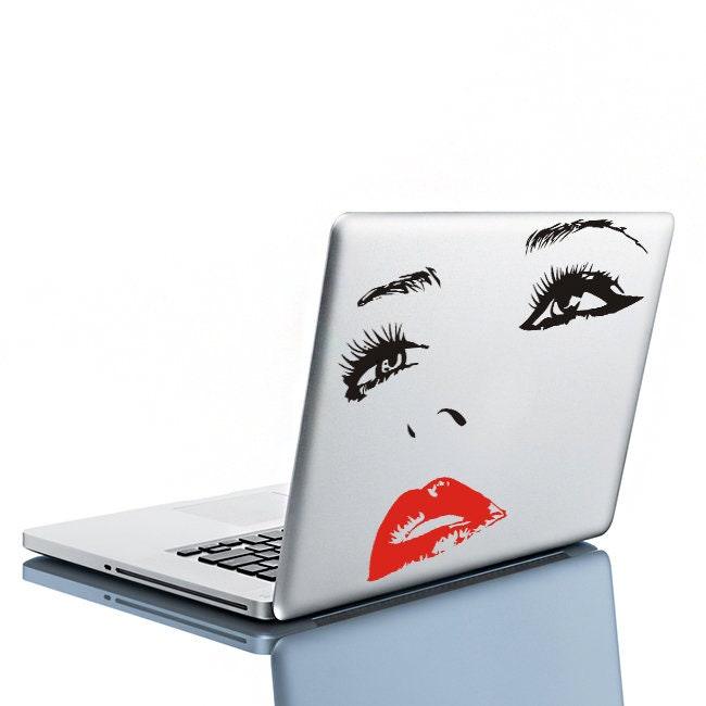 Stylish laptop decal featuring elegant face design with bold red lips and expressive eyes.