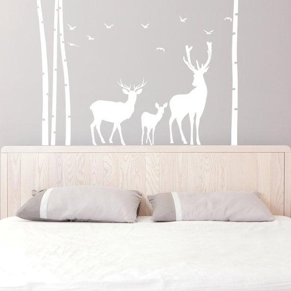 Deer wildlife wall decal featuring birch trees and silhouettes of deer in a nursery setting.