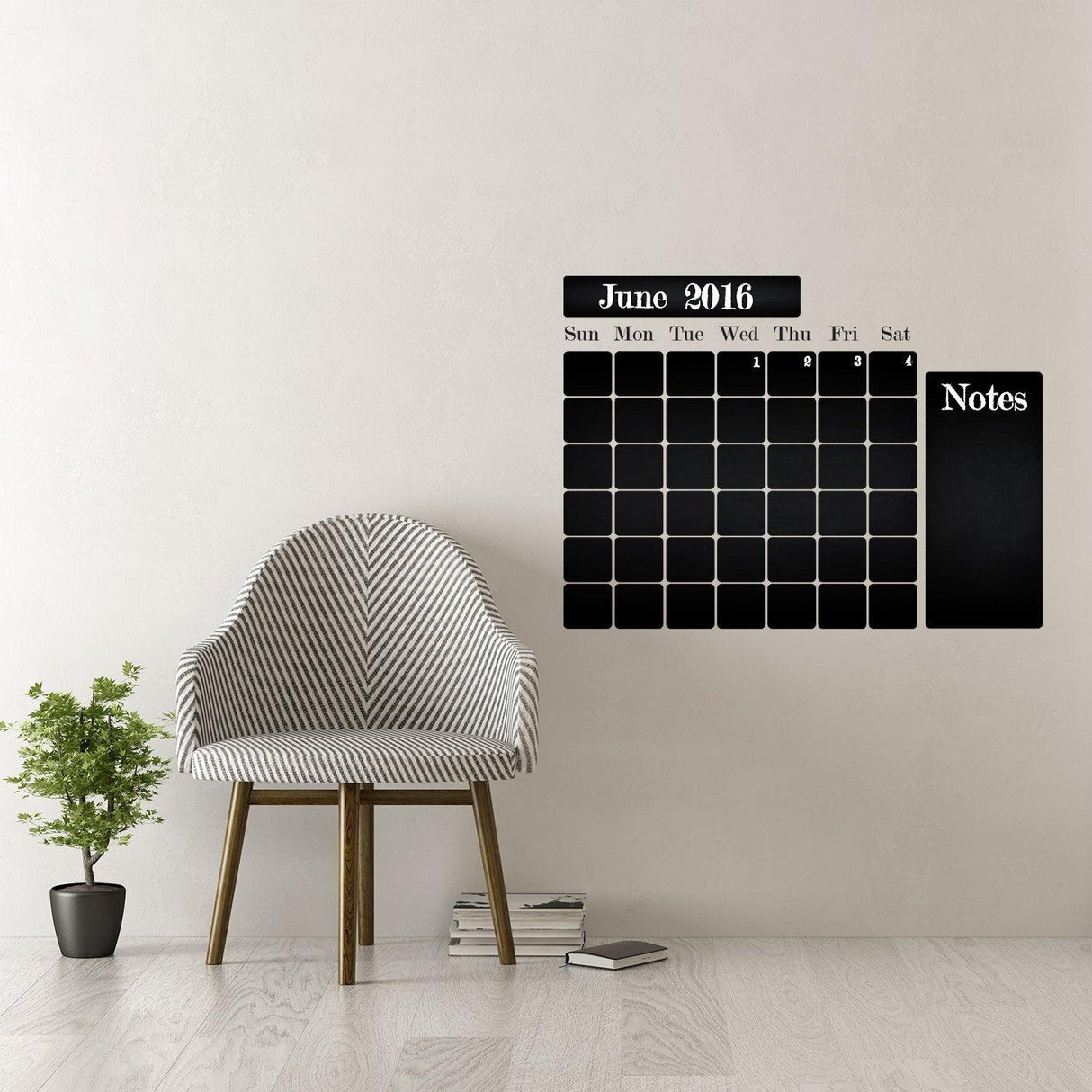 Chalkboard wall planner for June 2016, featuring days of the week and notes section, beside a modern chair and plant.