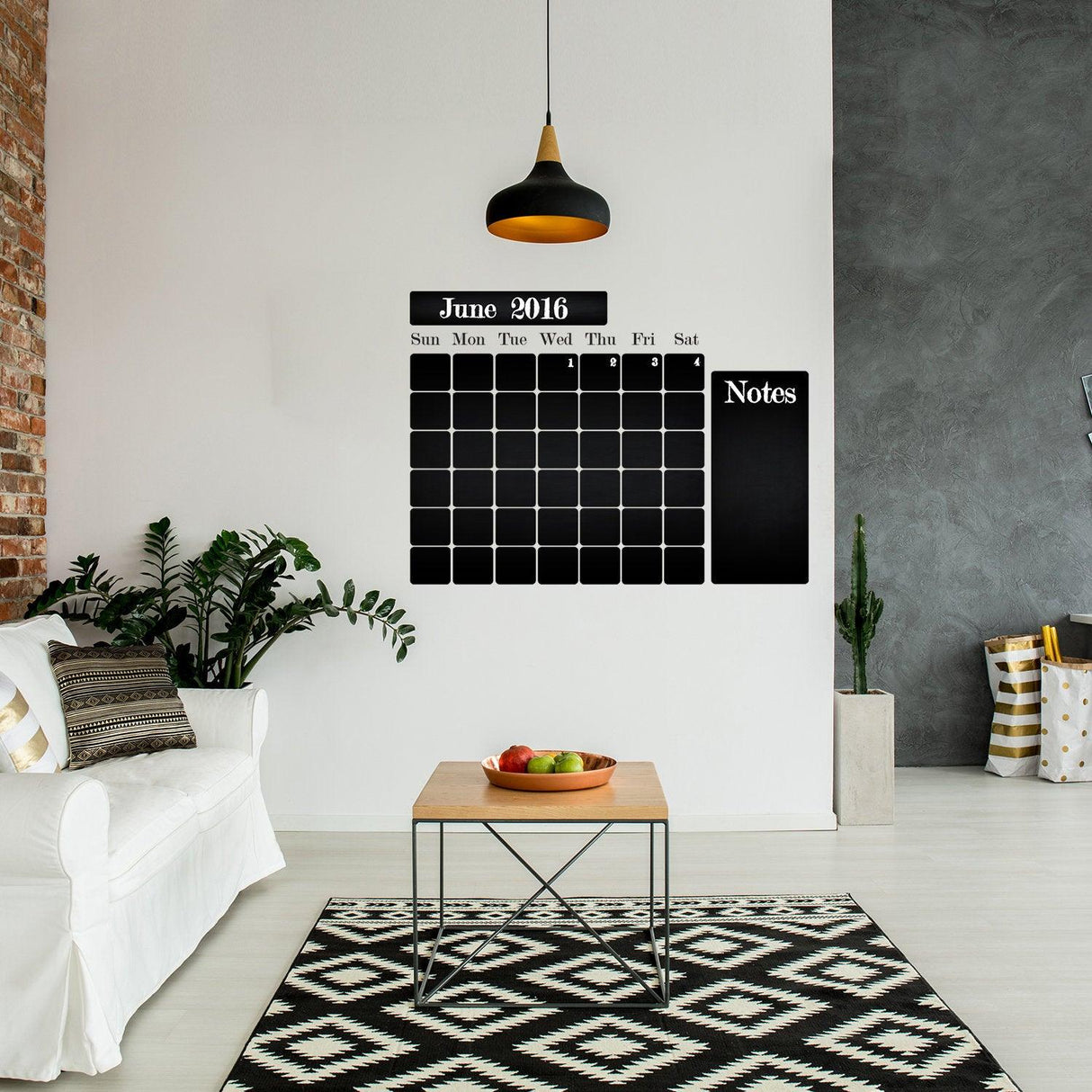Chalkboard wall planner in modern living room, featuring a monthly calendar and notes section for organizing tasks.