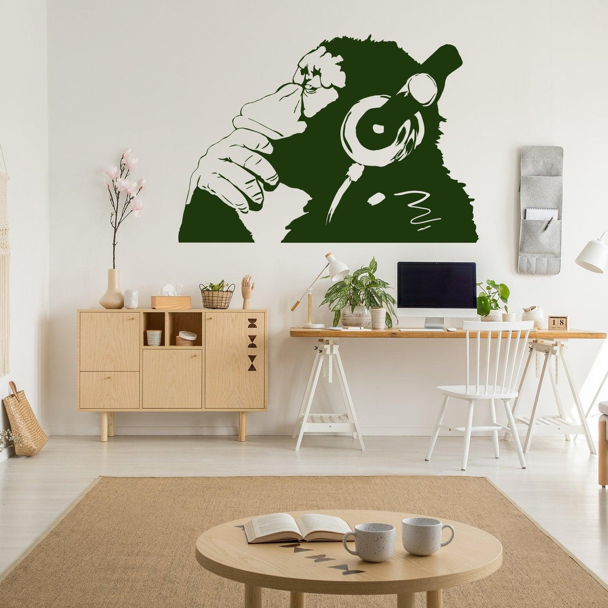 Banksy monkey with headphones wall sticker in modern living room decor.