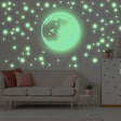 Glow in the dark moon and stars wall sticker in a kid's bedroom, creating a magical atmosphere on the ceiling.