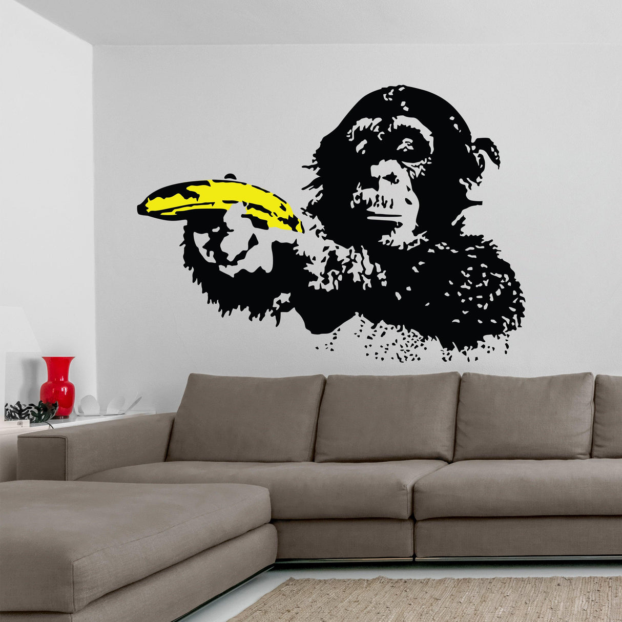 Banksy Monkey Wall Sticker vinyl decal on a living room wall, featuring a monkey pointing with a banana.