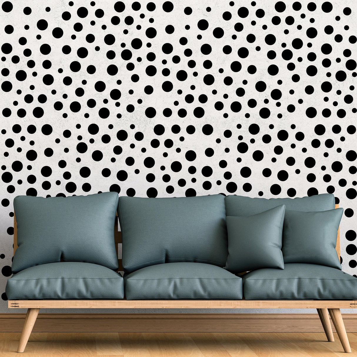 Polka dots wall decals in black on a white background behind a modern light blue sofa, perfect for girl or kid's room decor.