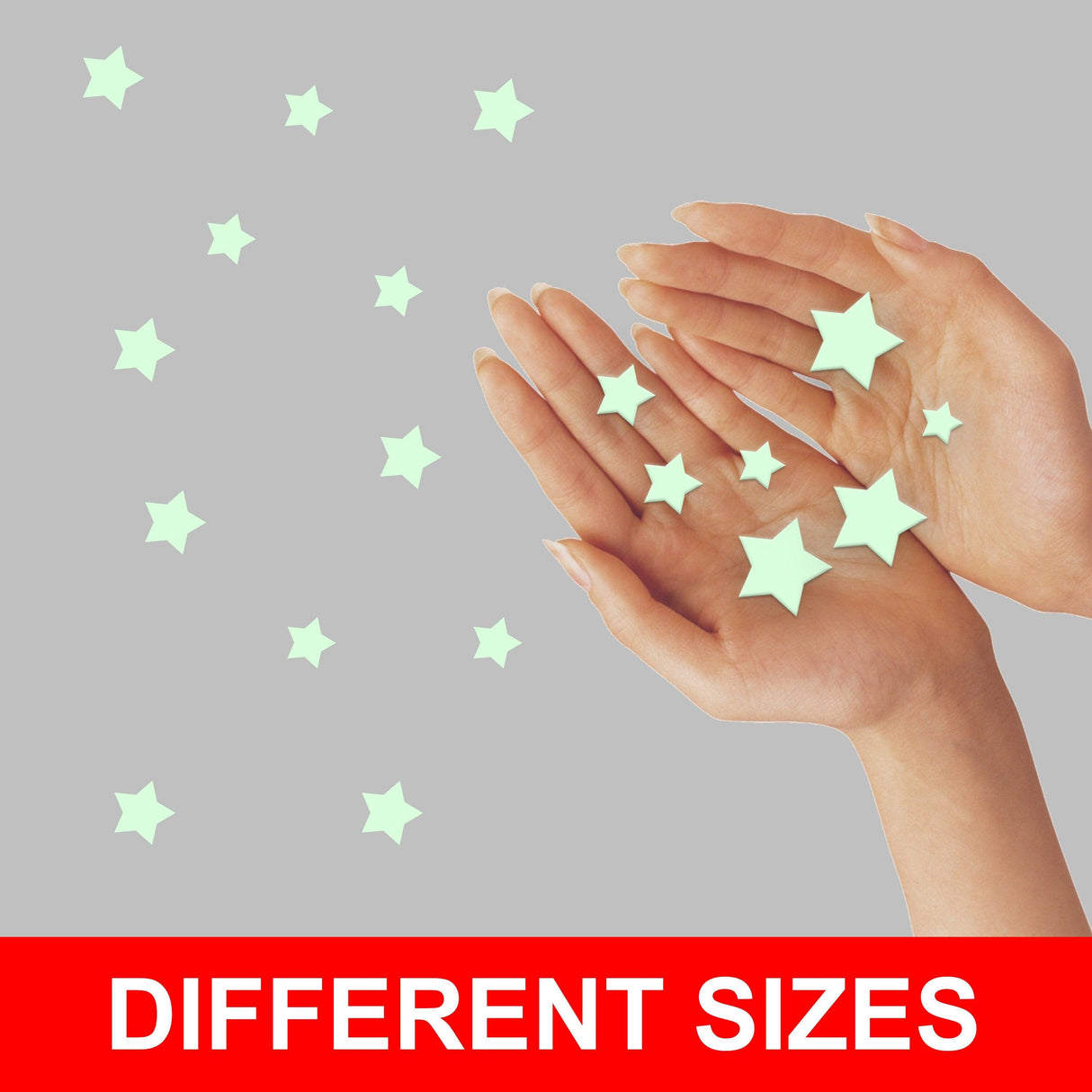 Hands holding glow in the dark star stickers in various sizes, ideal for decorating rooms.