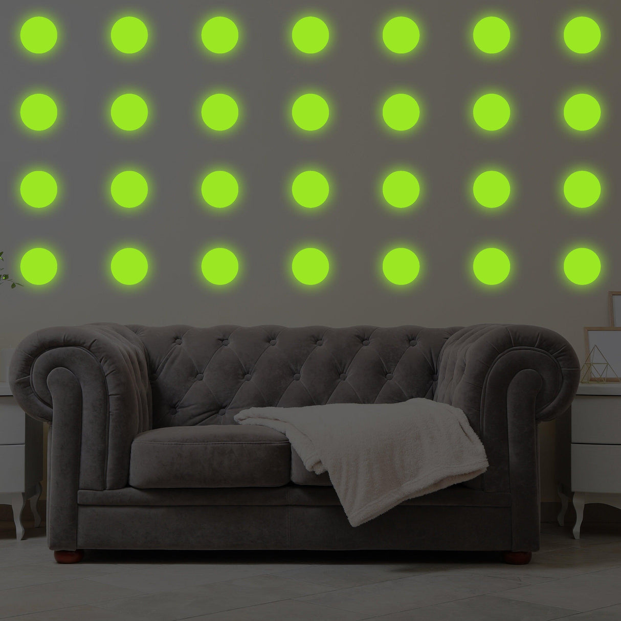 Glow in dark 40x dot wall stickers displayed on a living room wall above a cozy gray couch.