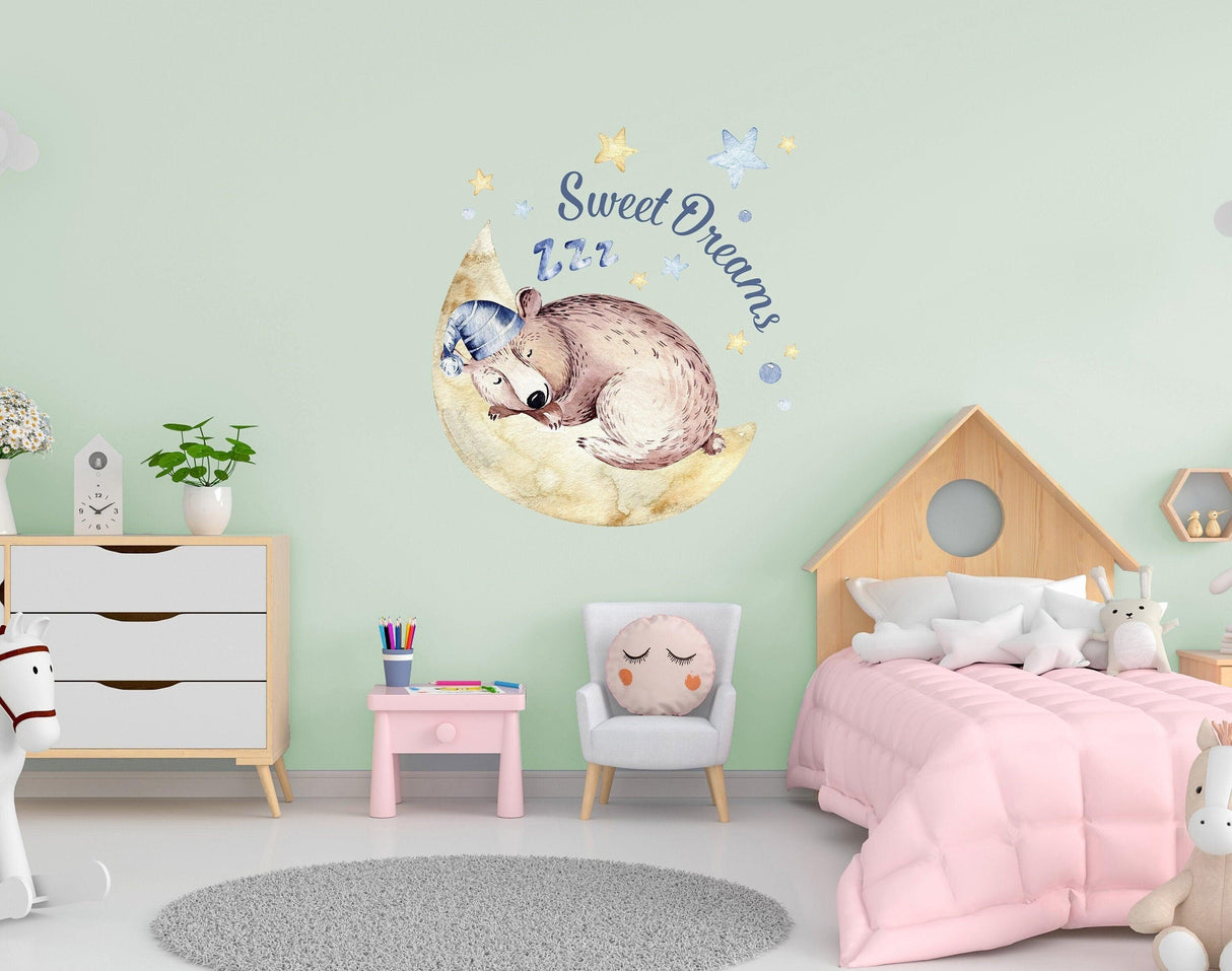 Nursery wall sticker with baby animal sleeping on moon, 'Sweet Dreams' text, ideal for kids' room decor.