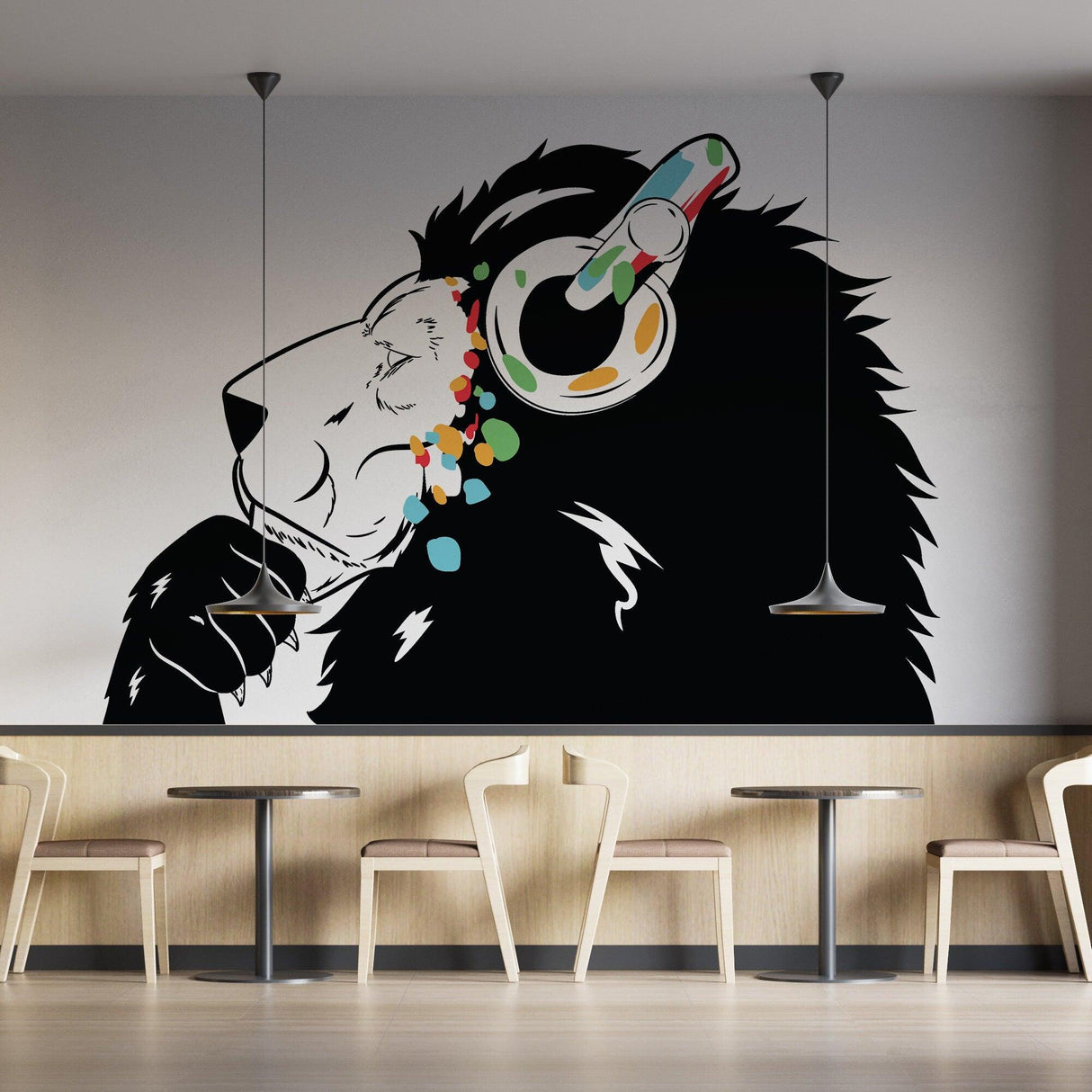 Thinking Lion Sticker featuring a lion with headphones, colorful decor, on a wall in a modern cafe setting.