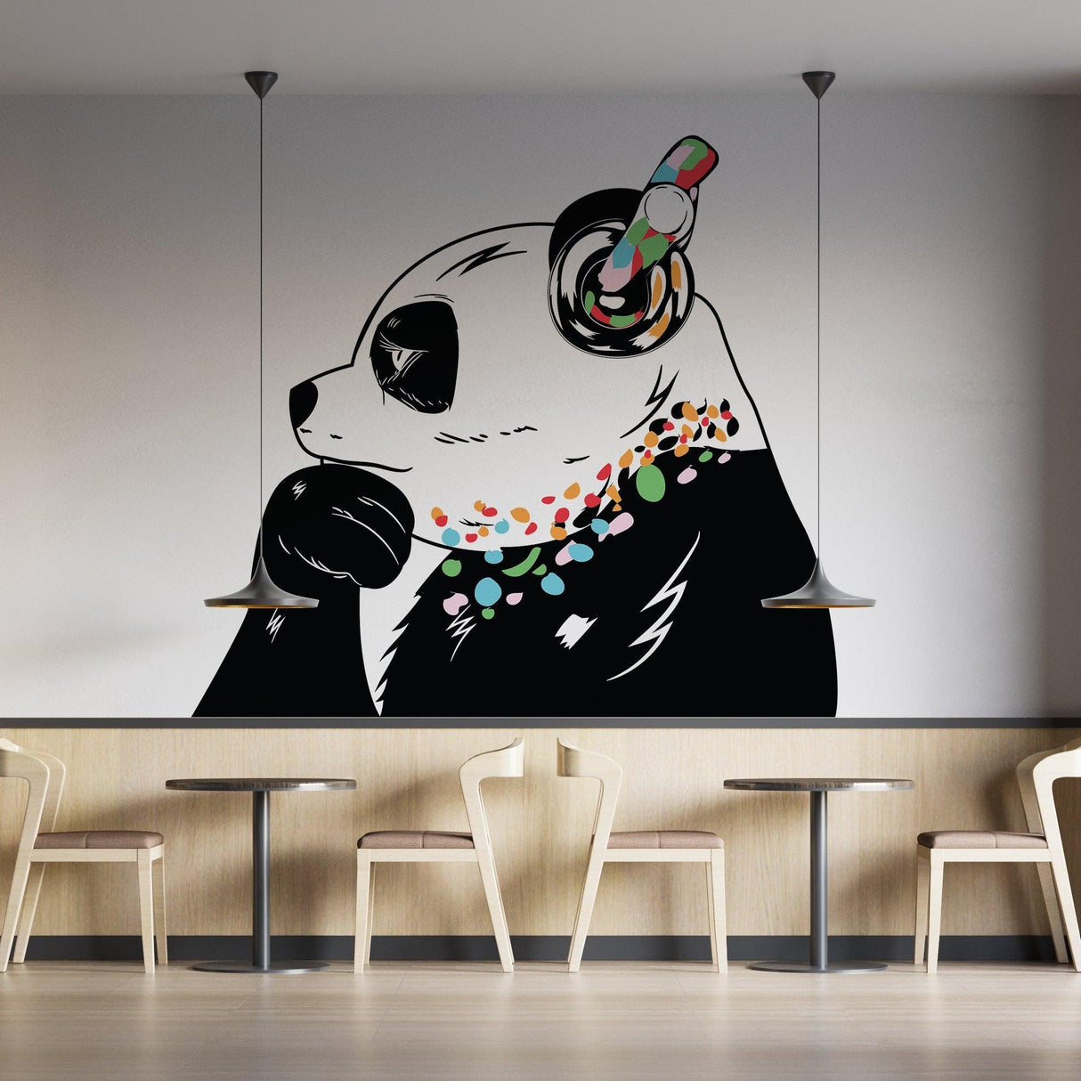 Thinking panda vinyl wall decal with headphones, featuring colorful details in a modern cafe setting.
