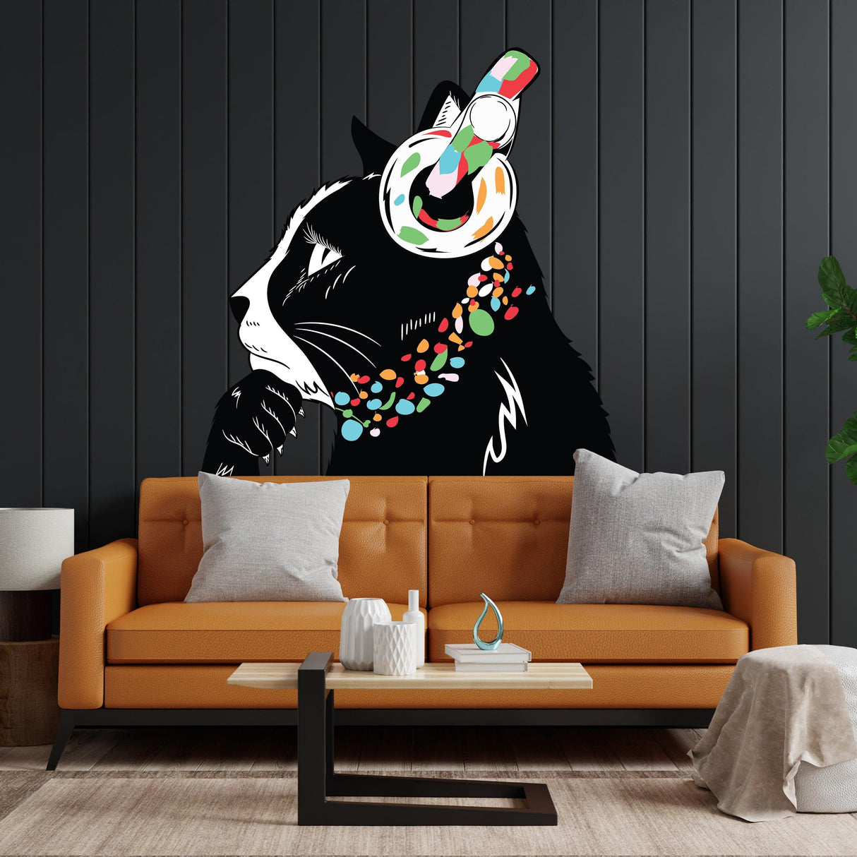Black and white cat wall decal with headphones and colorful collar above a stylish couch in a modern living room.