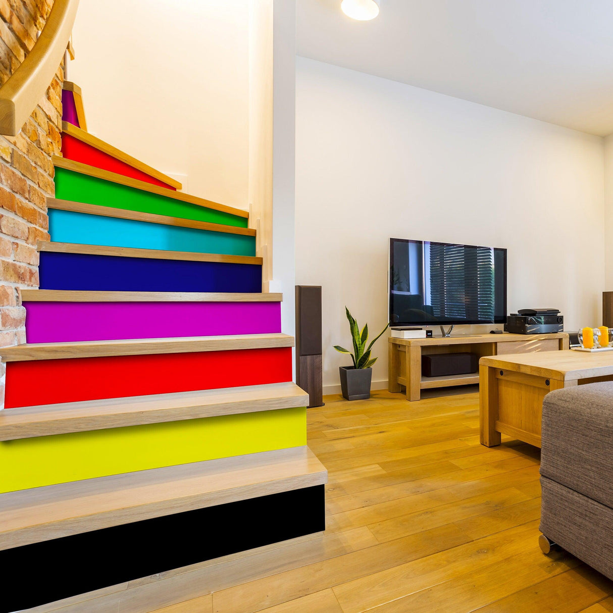 Colorful rainbow stair riser stickers decorating wooden stairs in a stylish living room.