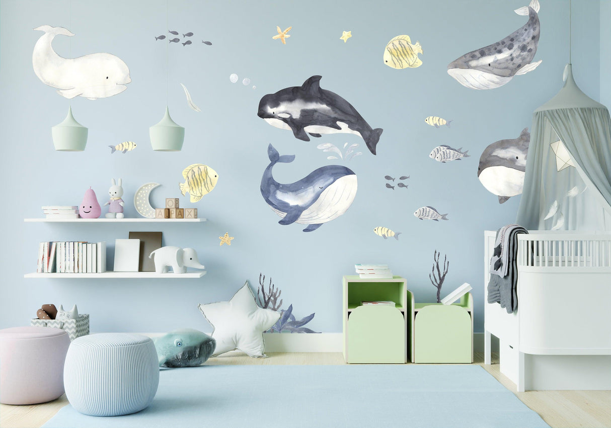 Colorful sea whales wall sticker in a kid's room with playful underwater scene and vibrant decor.