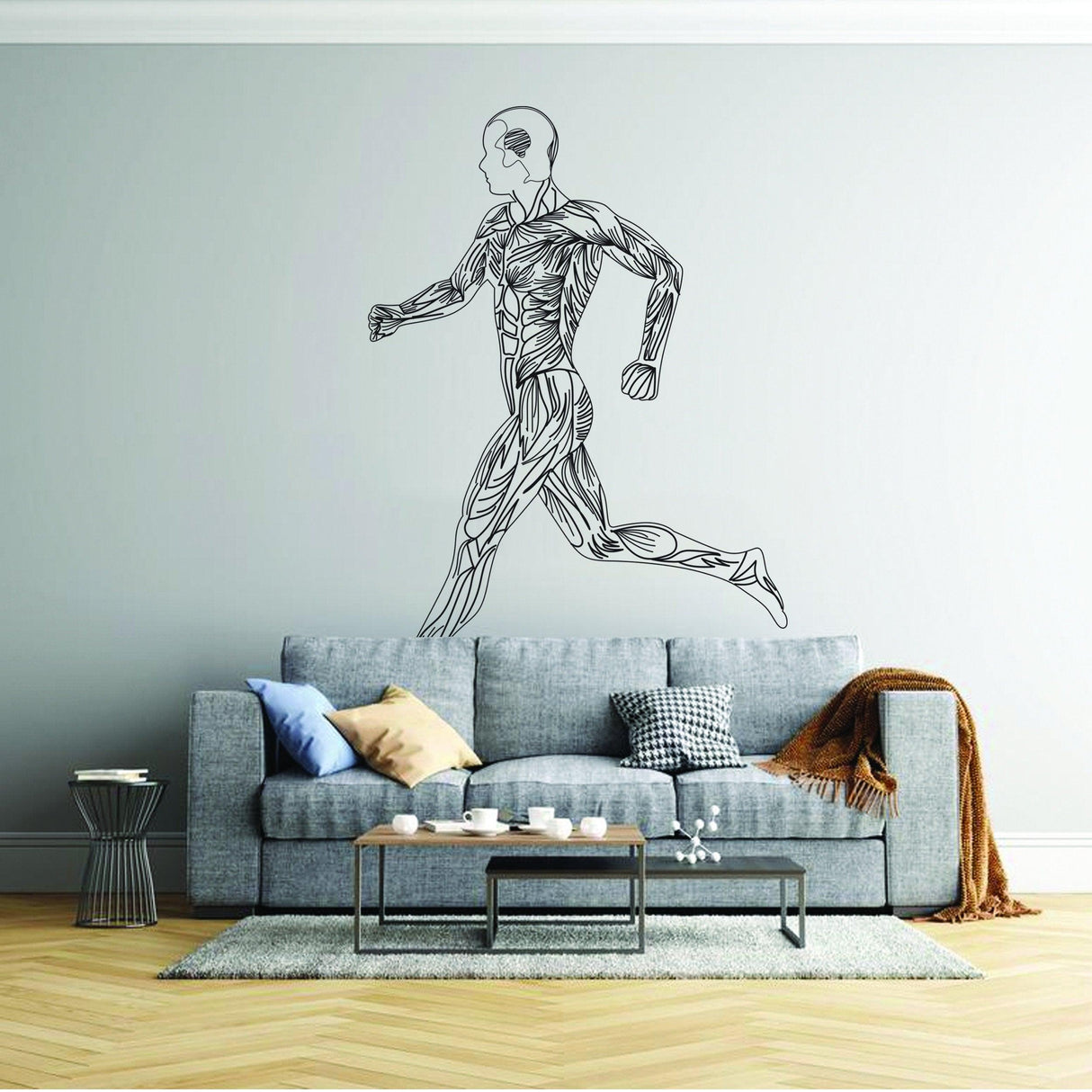 Mens body silhouette wall decal of a running figure in a stylish living room setting.