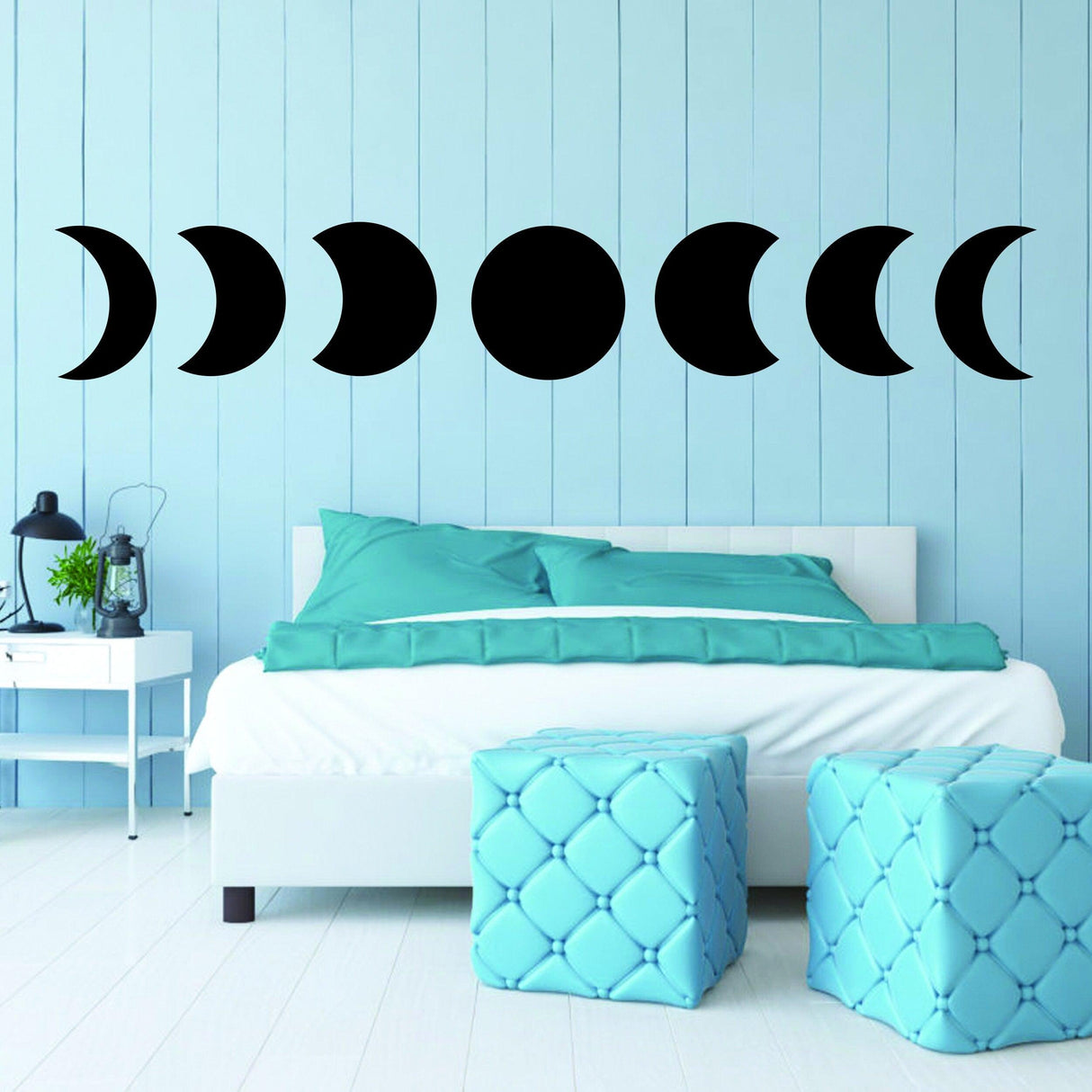 Moon Phase Wall Decor Sticker on blue wall above a bed, featuring different phases of the moon in stylish vinyl decal.