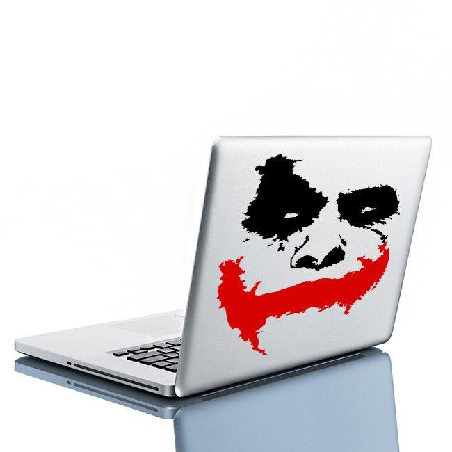 Joker wall sticker on a laptop featuring a black and red clown face design, perfect for fans of the iconic villain.