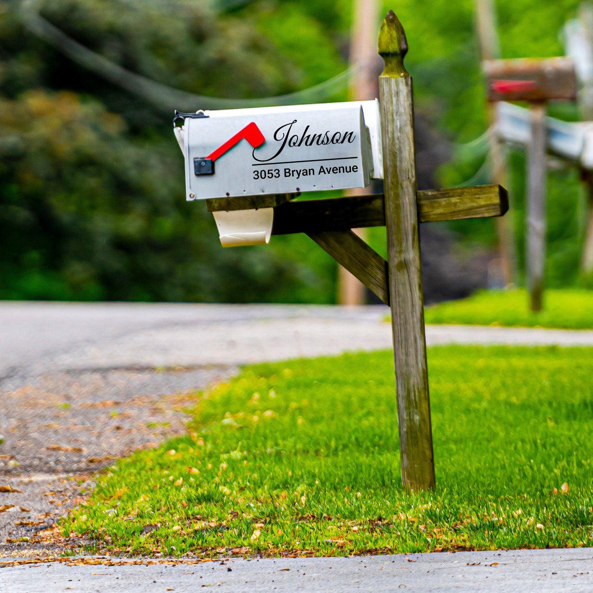 Personalized mailbox decal showcasing a custom house address on a vinyl sticker in a residential setting.