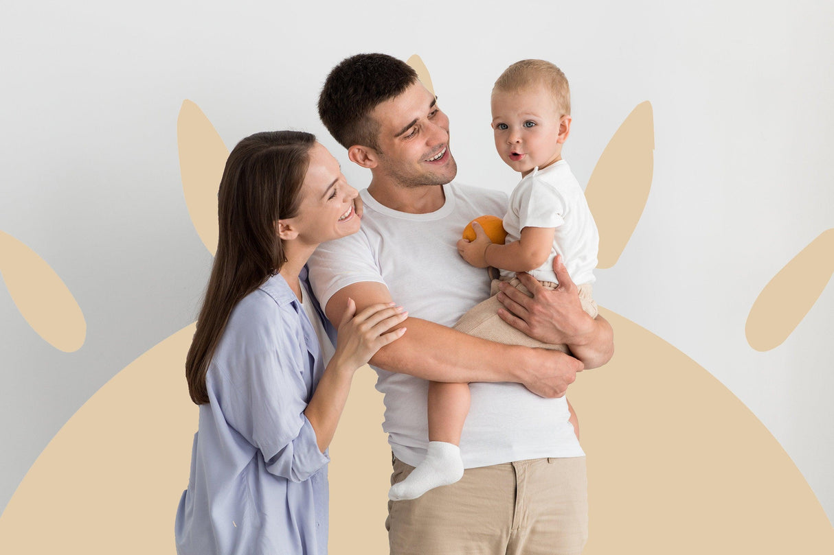 Happy family with toddler against a Boho Sun wall decal in a nursery, showcasing warmth and joy in home decor.