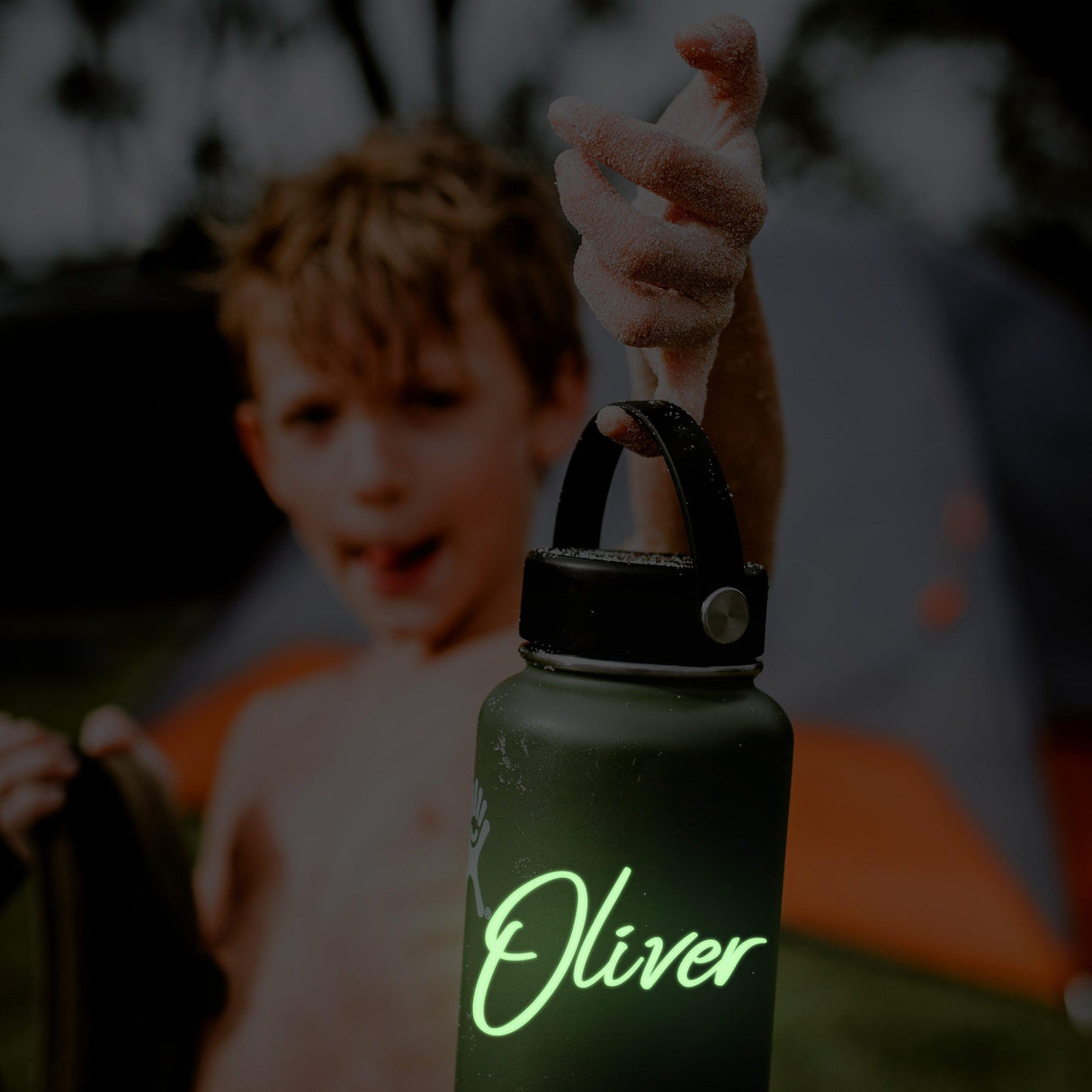 Personalized vinyl name decal on a water bottle, glowing in the dark, personalized for Oliver.