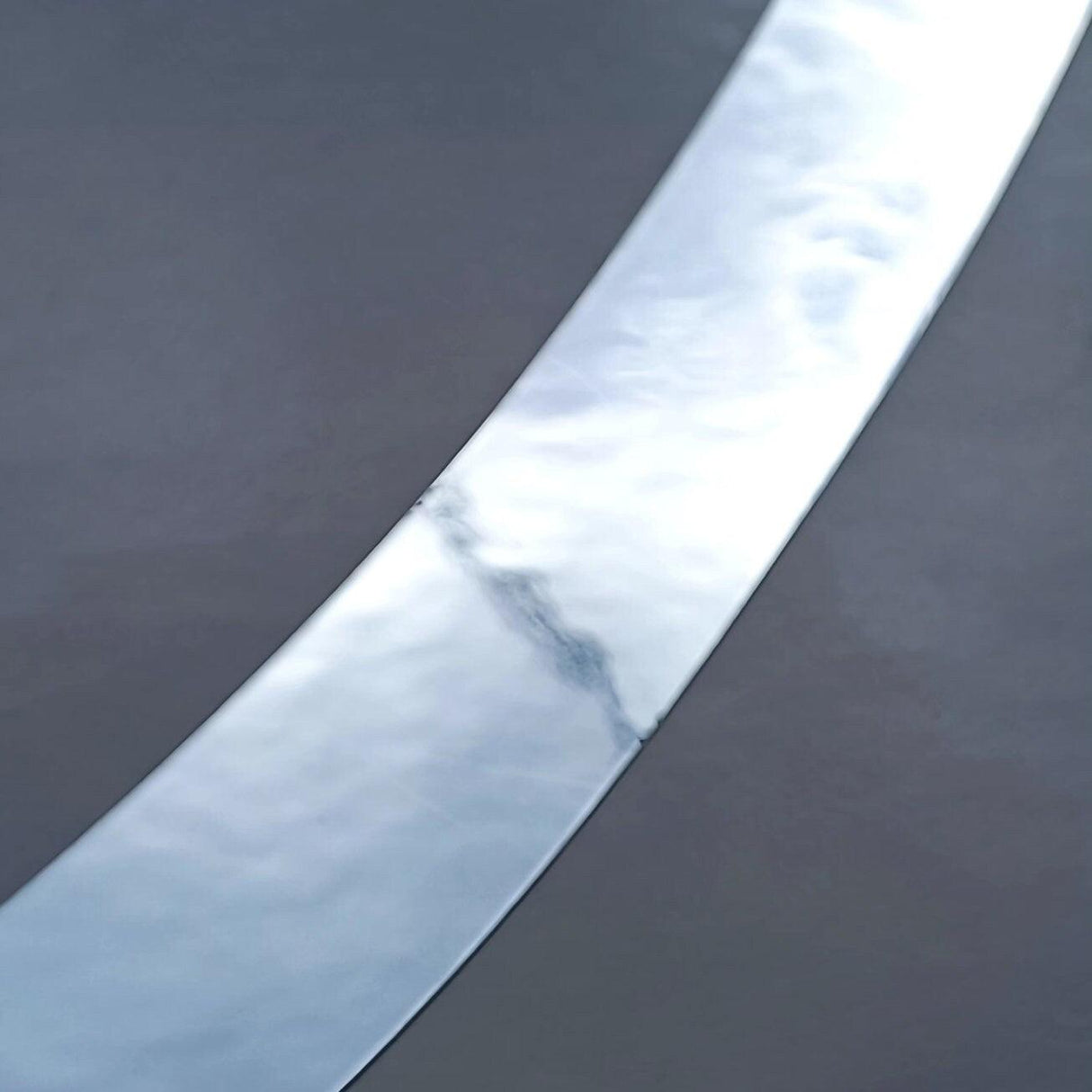 Close-up of a smooth silver chrome vinyl surface for personalized name stickers.