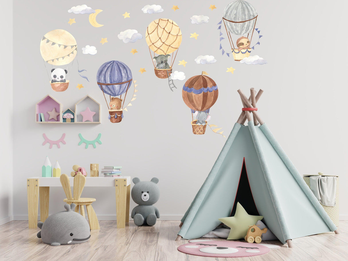 Colorful hot air balloon wall stickers with cute animals and clouds in a whimsical nursery design.