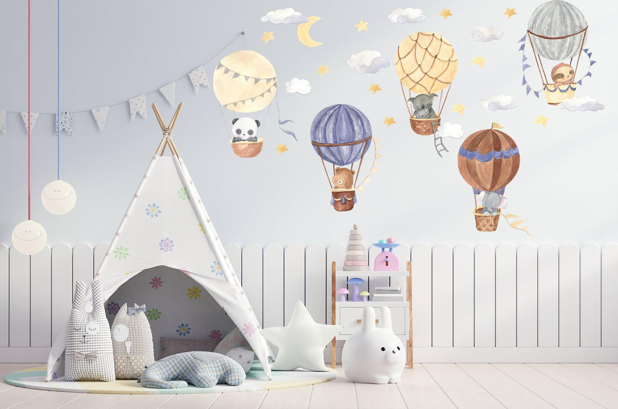 Whimsical hot air balloon wall stickers featuring cute animals, stars, and clouds in a nursery setting.