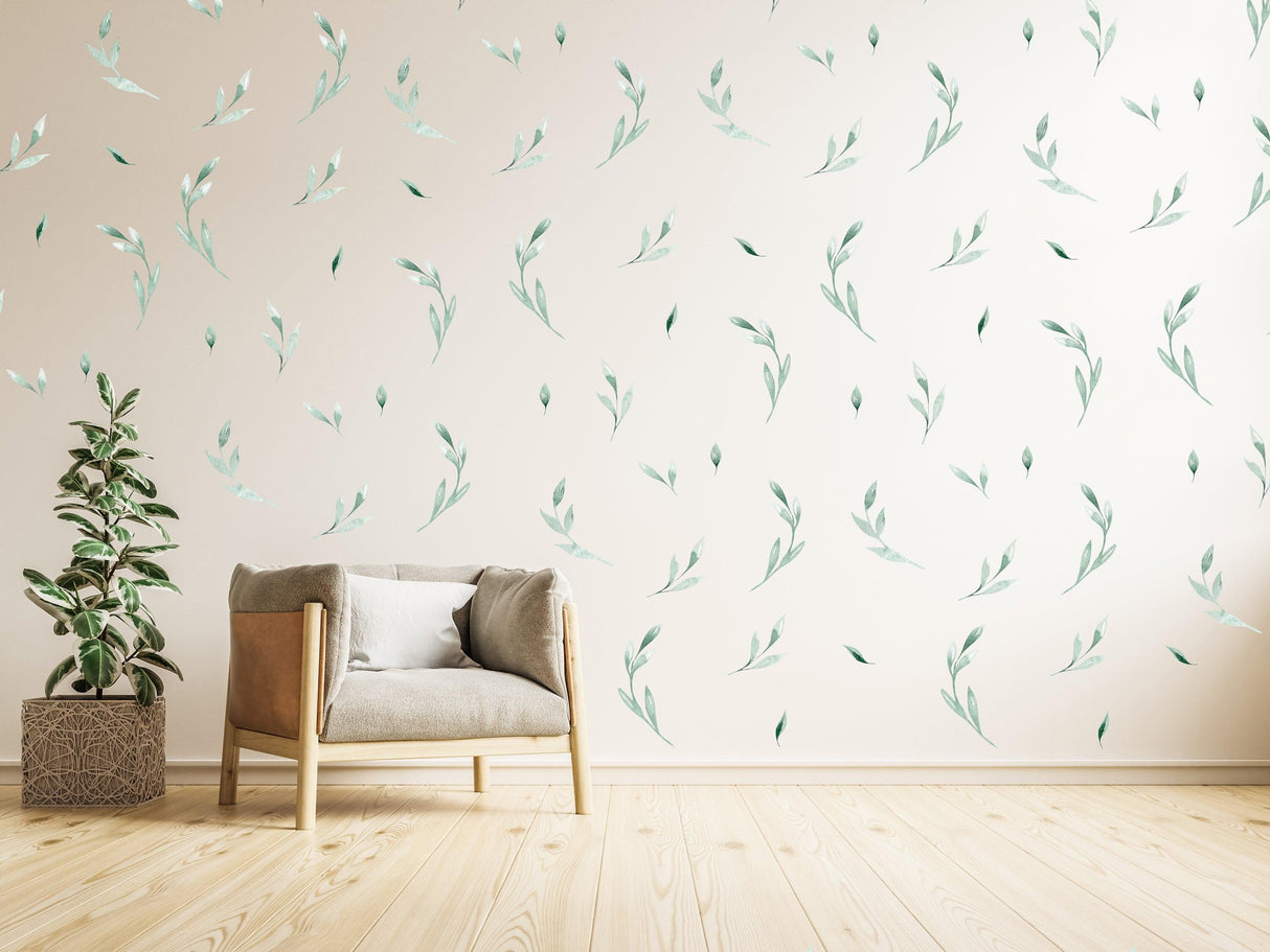 Leaf wall decor stickers featuring green leaf designs on a light wall, enhancing a cozy living space.